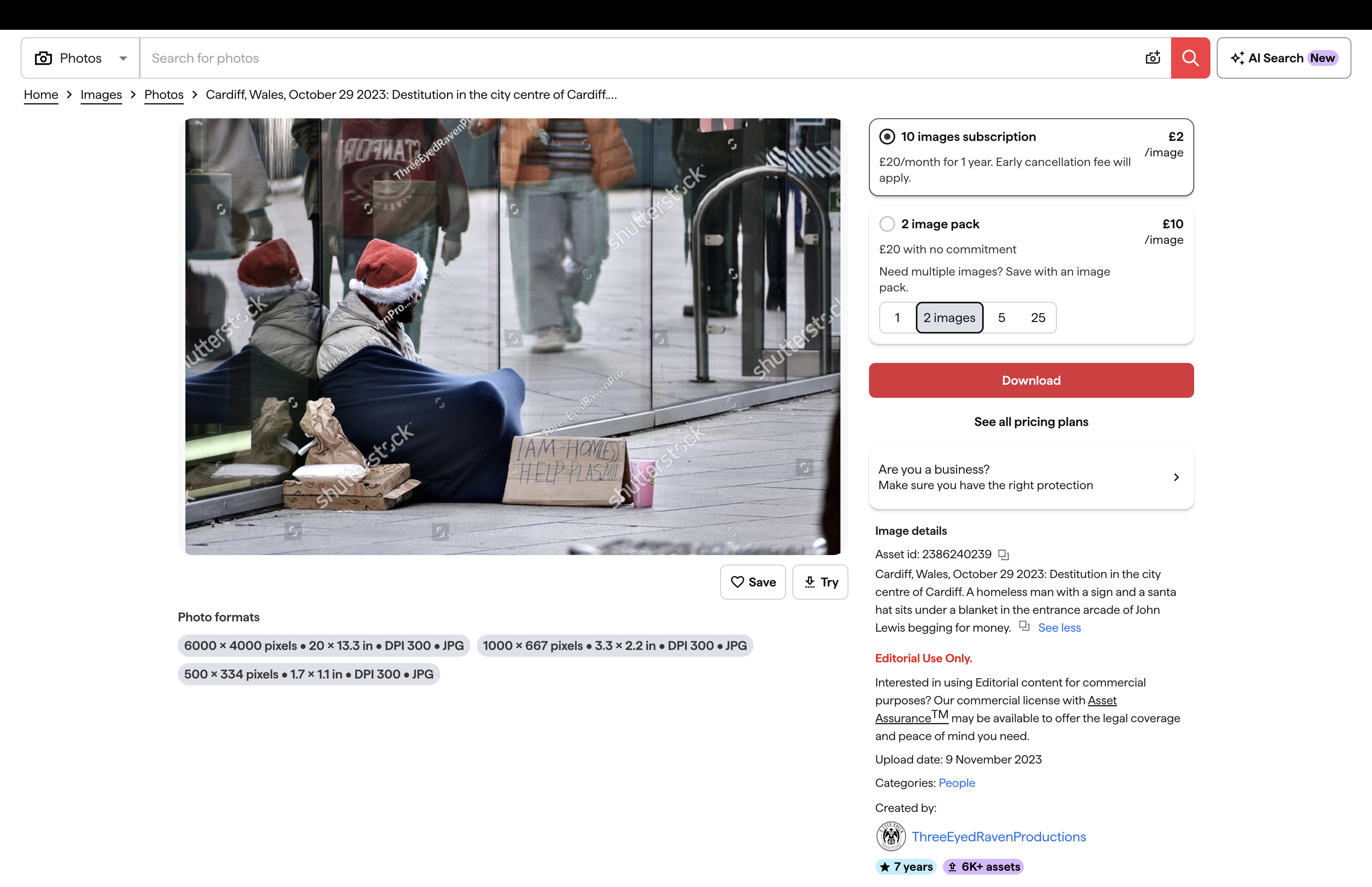 Homeless man in a Cardiff city-centre shop doorway in a retail environment.